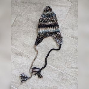 Brown winter hat with pom-poms